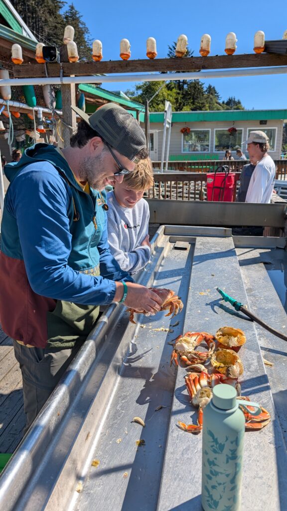 two men cleaning a crab